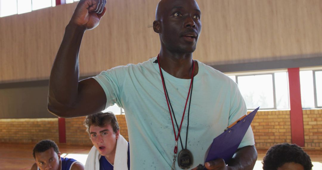 Determined Coach Motivating Basketball Team in Gym Training Session