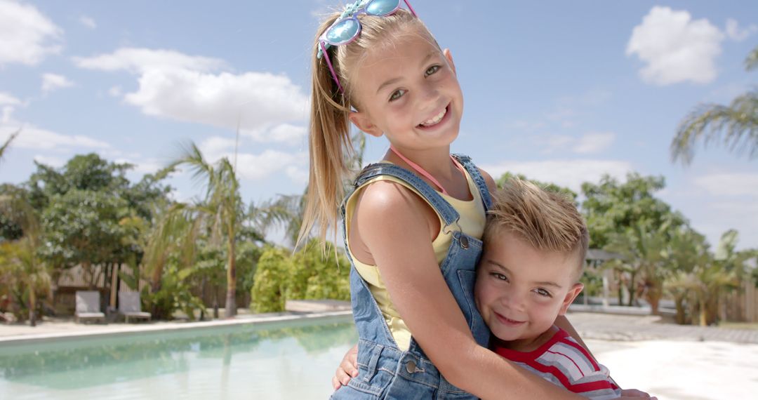 Joyful Siblings Embracing by Poolside in Summer - Free Images, Stock Photos and Pictures on Pikwizard.com