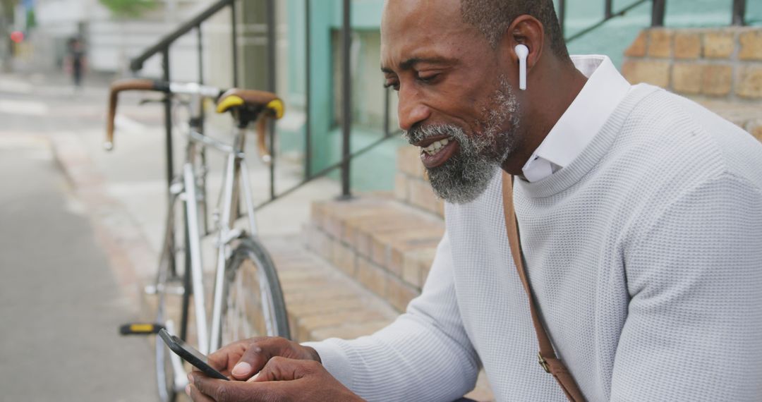 Senior African American Man Using Smartphone While Enjoying Outdoors - Free Images, Stock Photos and Pictures on Pikwizard.com