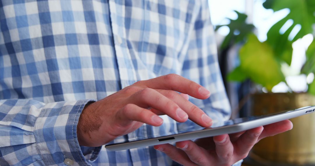 Person Using Tablet with Blue Plaid Shirt Indoors - Free Images, Stock Photos and Pictures on Pikwizard.com