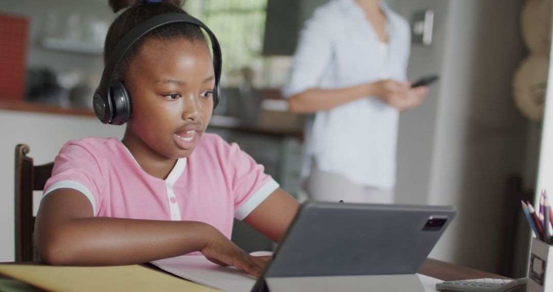 Focused African American Girl Studying Online with Tablet and Headphones - Free Images, Stock Photos and Pictures on Pikwizard.com