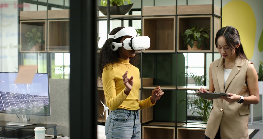 Women Collaborating with VR and Tablets in Innovative Office Space