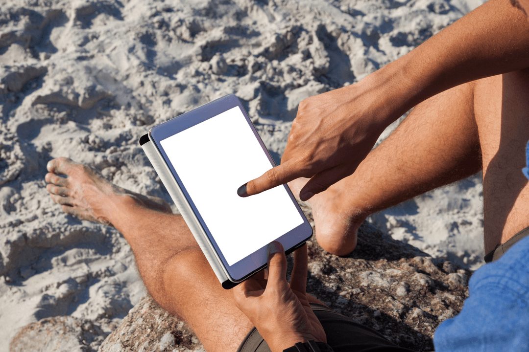Person Relaxing on Beach with Tablet on Sunny Day
