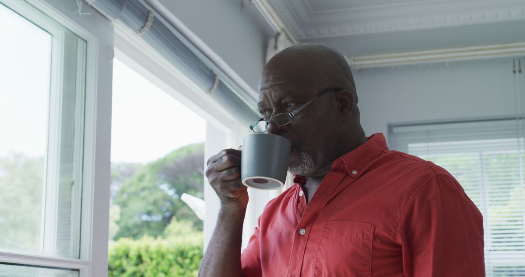 African American Man Enjoying Morning Coffee Near Window - Free Images, Stock Photos and Pictures on Pikwizard.com