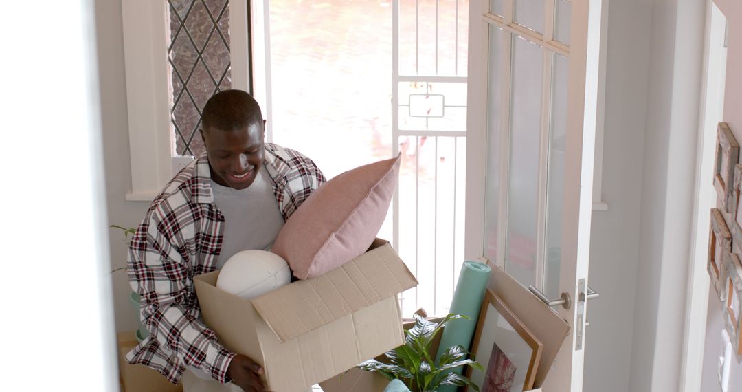 Happy african american man moving into new home - Free Images, Stock Photos and Pictures on Pikwizard.com