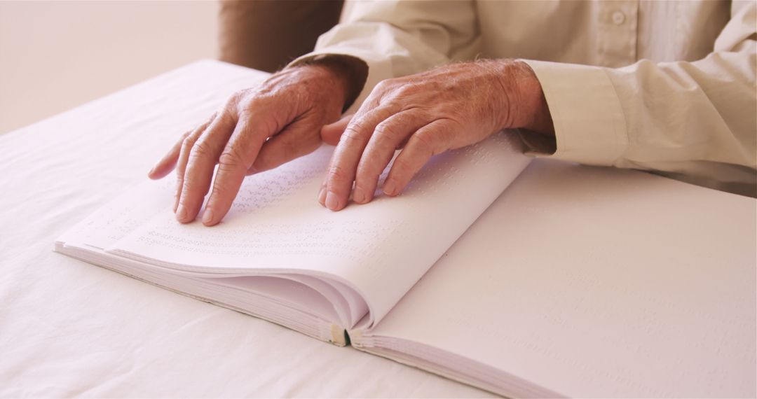 Senior Man Reading Braille Book with Hands Touching Pages - Free Images, Stock Photos and Pictures on Pikwizard.com