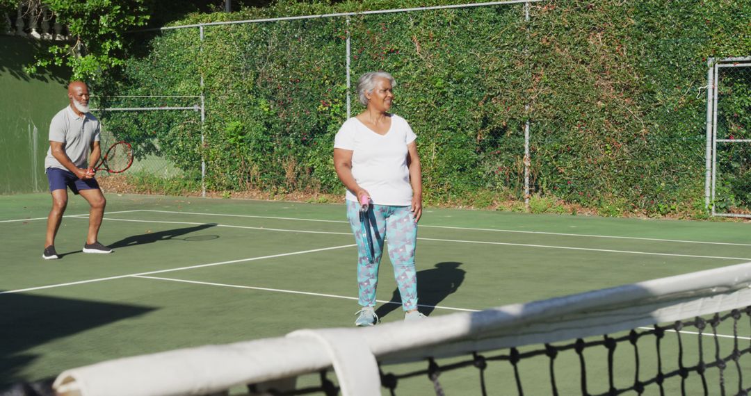 Elderly Couple Enjoying Game of Tennis on Outdoor Court - Free Images, Stock Photos and Pictures on Pikwizard.com