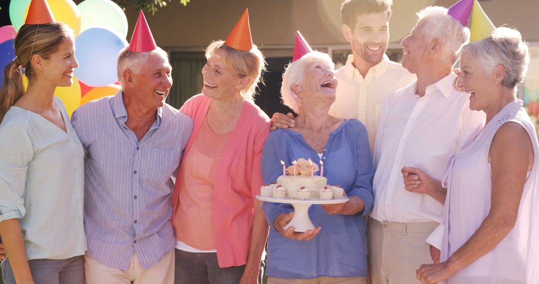 Seniors Celebrating Birthday Outdoors with Party Hats and Cupcakes - Free Images, Stock Photos and Pictures on Pikwizard.com