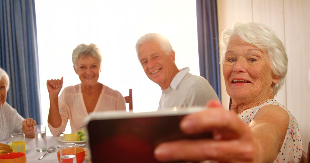 Happy Senior Friends Taking Selfie During Breakfast at Home - Free Images, Stock Photos and Pictures on Pikwizard.com