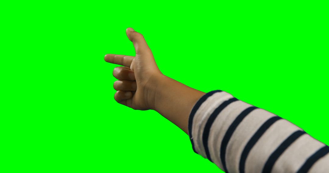 Child Pointing Hand with Striped Sleeve Isolated on Green Background - Free Images, Stock Photos and Pictures on Pikwizard.com