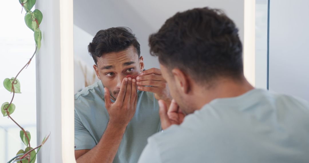 Man Inserting Contact Lenses in Front of Bathroom Mirror - Free Images, Stock Photos and Pictures on Pikwizard.com