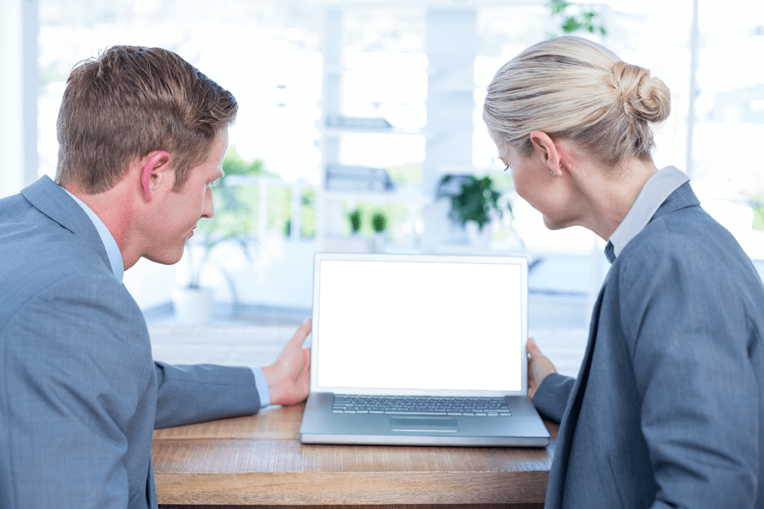 Business Professionals Reviewing Transparent Laptop Screen in Office