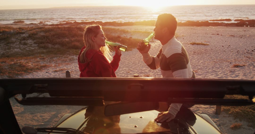 Couple Enjoying Beers on Beach at Sunset Near Off-Road Vehicle - Free Images, Stock Photos and Pictures on Pikwizard.com