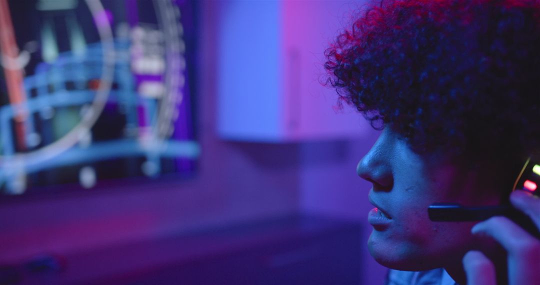 Gamer Using Headset with Futuristic Lighting Background