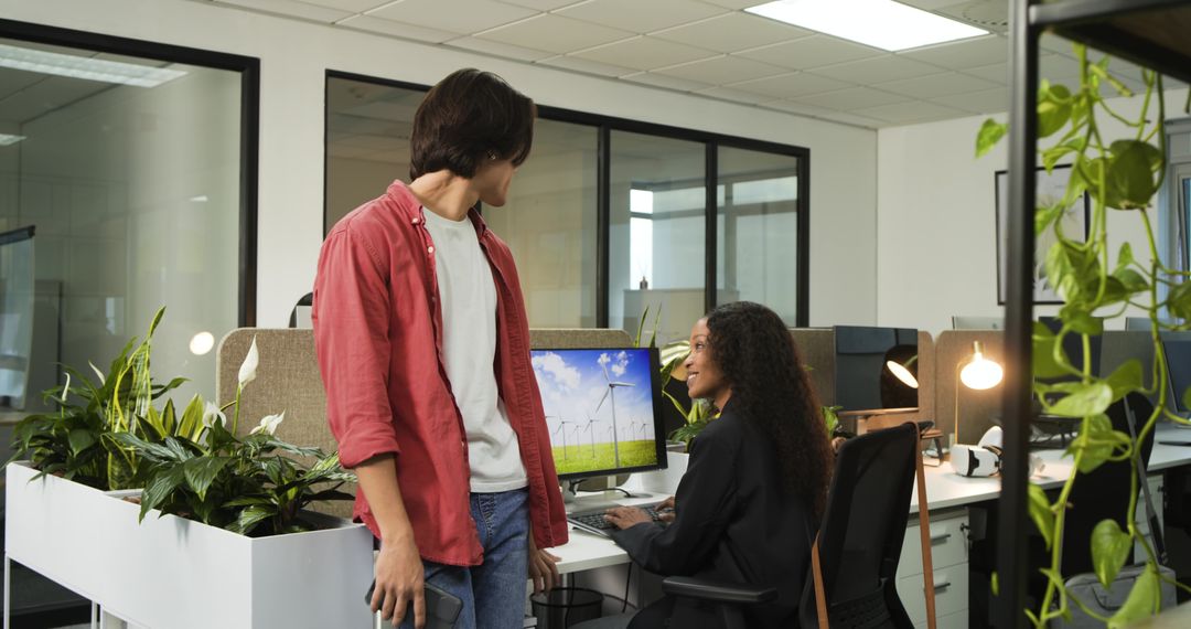 Diverse Colleagues Chatting in Modern Office with Green Open Space Design
