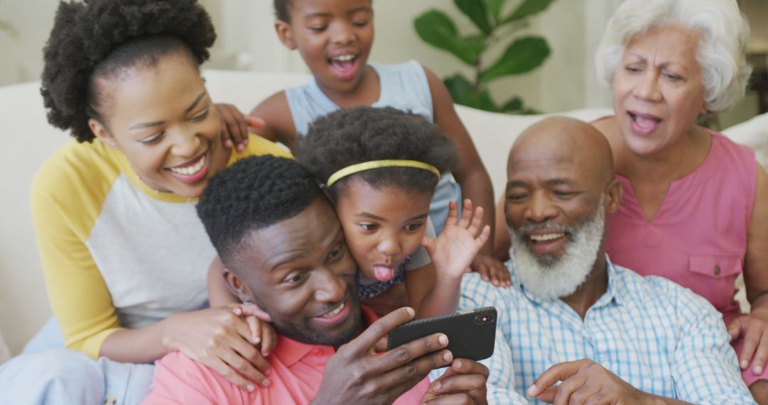 Joyful Multigenerational Family Using Smartphone Together