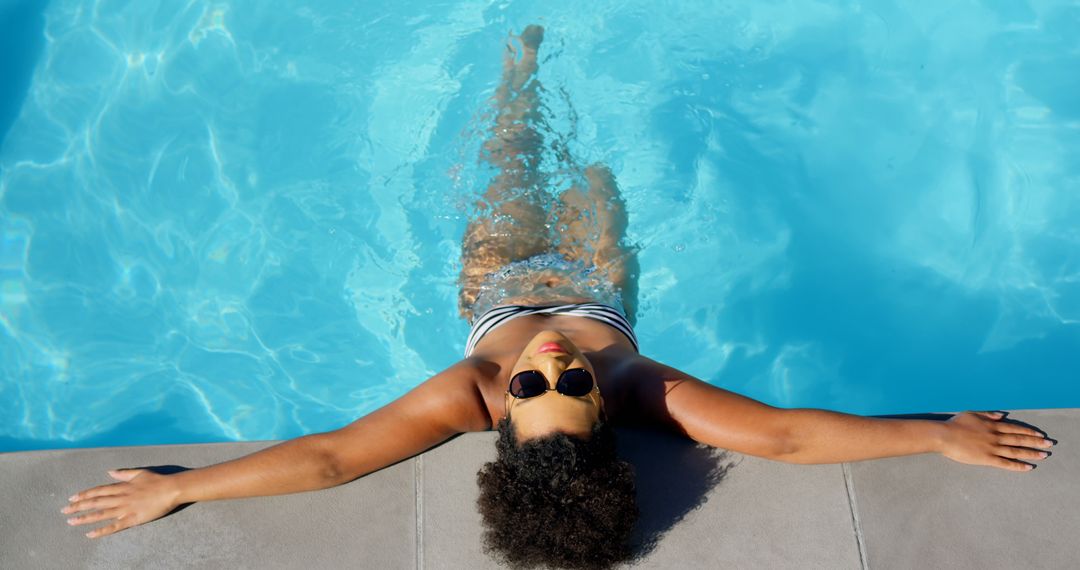 Relaxed Woman in Pool with Sunglasses Enjoying Summer - Free Images, Stock Photos and Pictures on Pikwizard.com