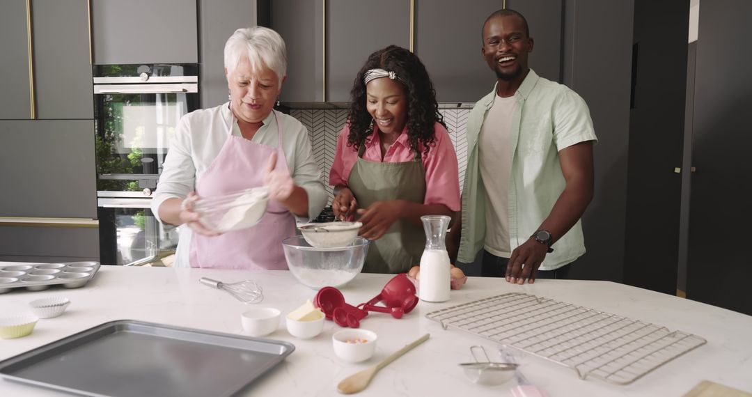 Multigenerational family baking together in modern kitchen, smiling and sifting flour
