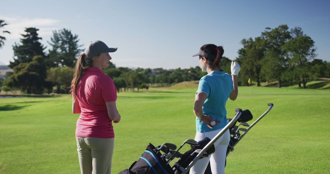 Female Golfers Engaged in Conversation on Sunny Day