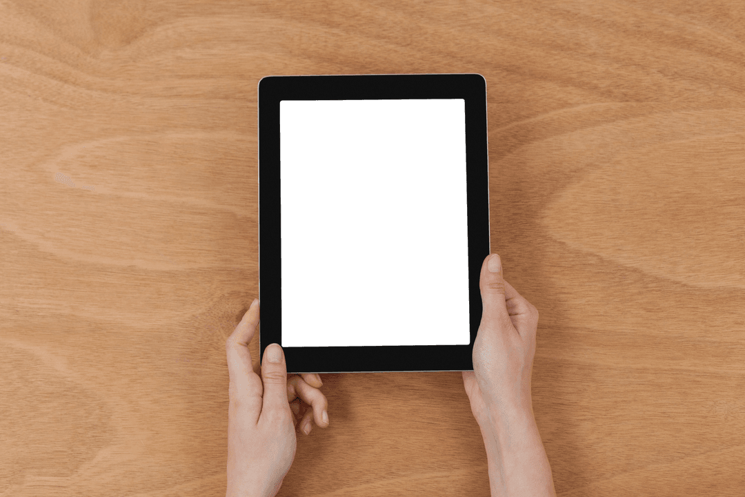 Close-up of Hands Holding Transparent Tablet on Wooden Desk