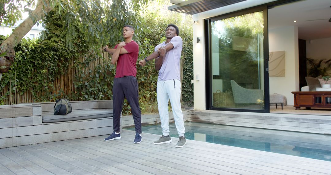 Diverse Male Friends Stretching by Pool in Serene Modern Setting