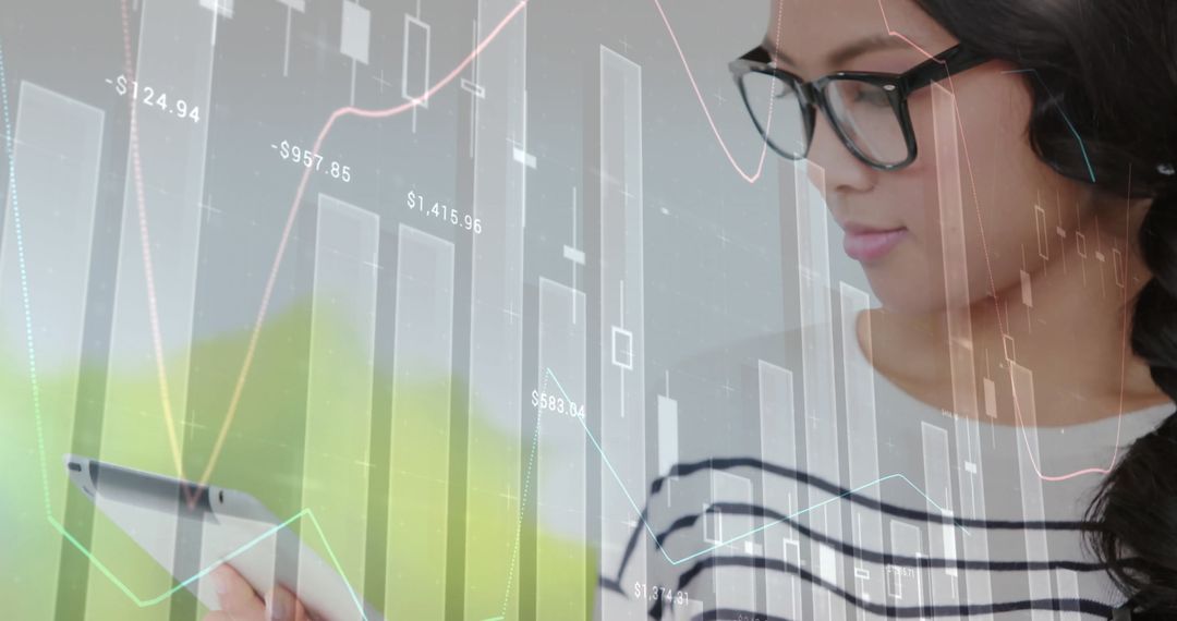 Asian Businesswoman Analyzing Financial Data Charts on Tablet