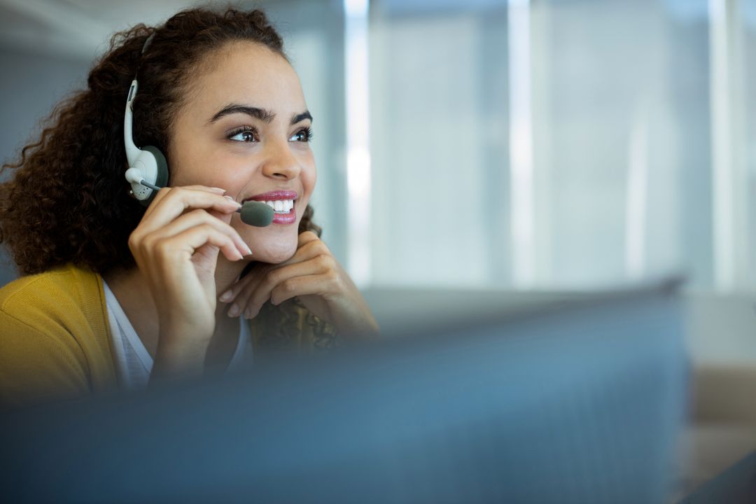 Smiling Professional Woman Using Headset in Modern Office