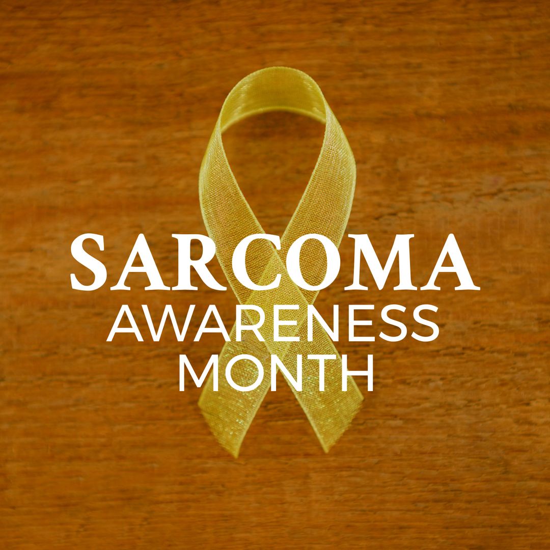Sarcoma Awareness Month with Yellow Ribbon on Wooden Background