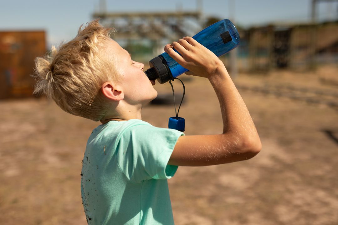 Caucasian Boy Drinking Water During Boot Camp Break - Free Images, Stock Photos and Pictures on Pikwizard.com