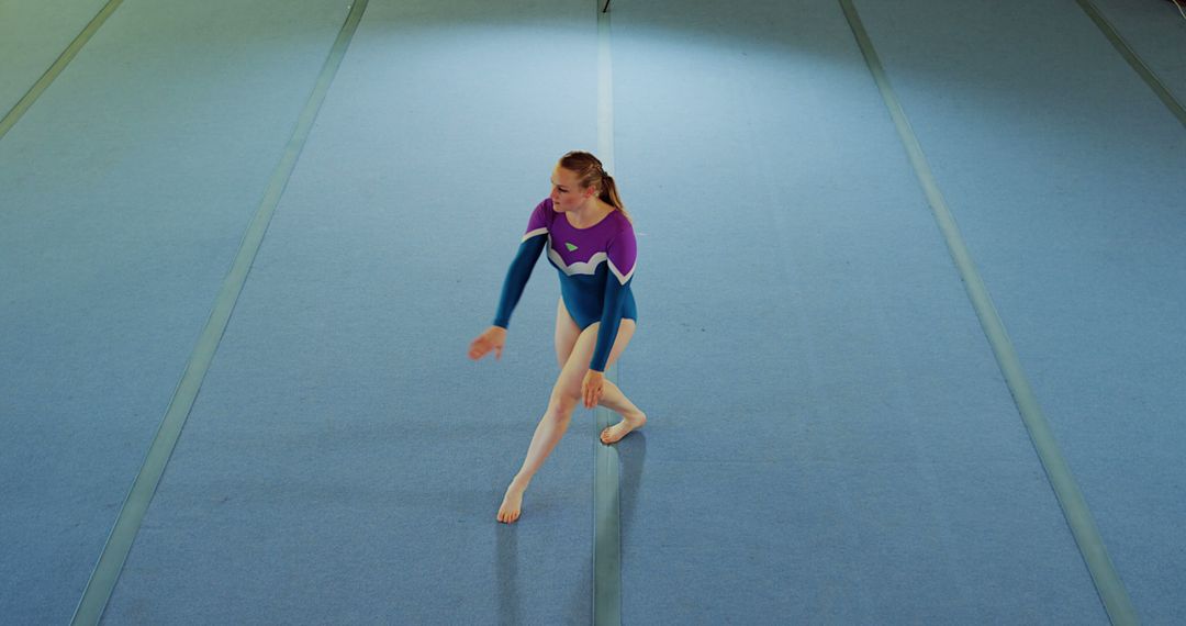 Teenage Gymnast Practicing Routine on Gym Floor - Free Images, Stock Photos and Pictures on Pikwizard.com