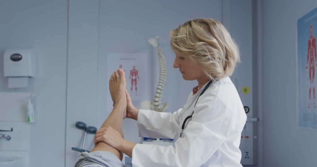 Female Physiotherapist Examining Patient's Leg in Clinic - Free Images, Stock Photos and Pictures on Pikwizard.com