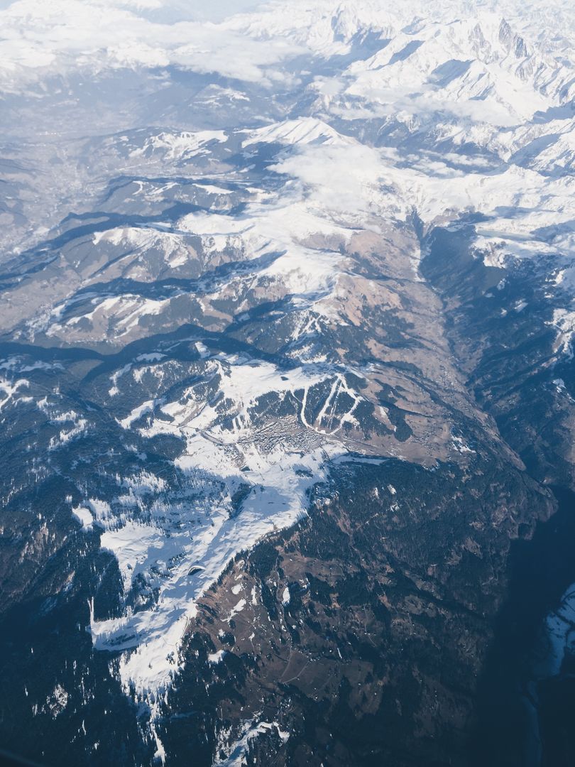 Breathtaking Aerial View of Snow-Covered Mountain Range - Free Images, Stock Photos and Pictures on Pikwizard.com