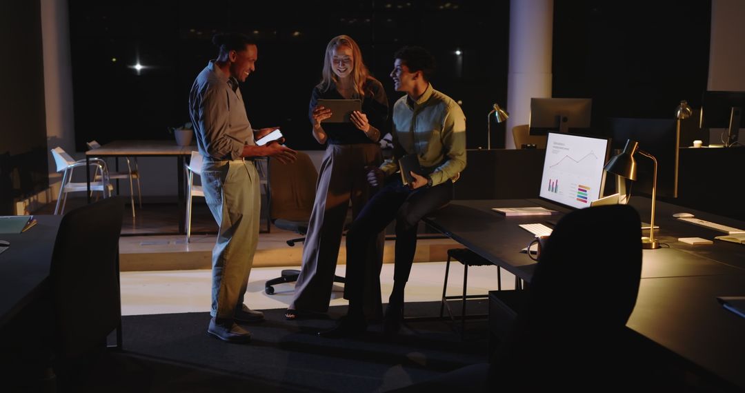 Diverse Team Analyzing Data on Tablet in Modern Office