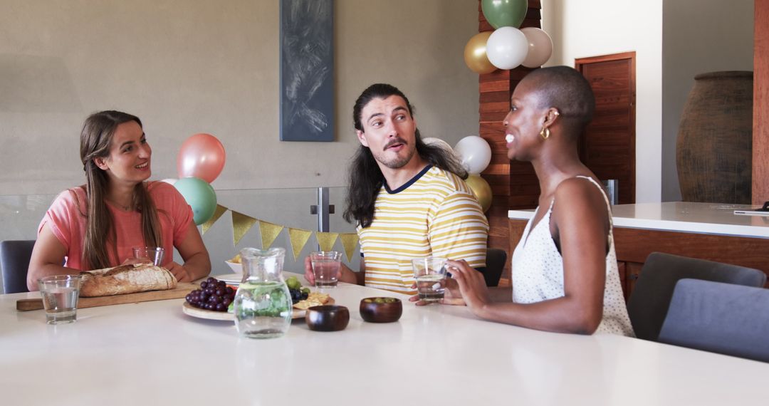 Friends Socializing Around Table Sharing Laughter and Food