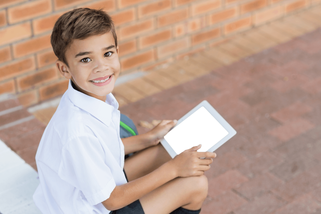 Happy Boy Holding Tablet with Transparent Screen Outdoors