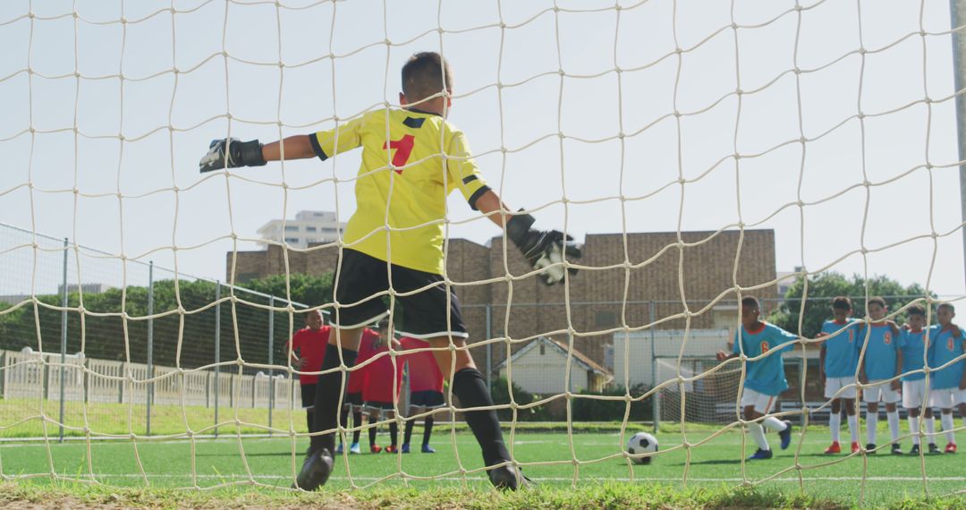 Goalkeeper Preparing for Penalty Kick During Youth Soccer Game - Free Images, Stock Photos and Pictures on Pikwizard.com