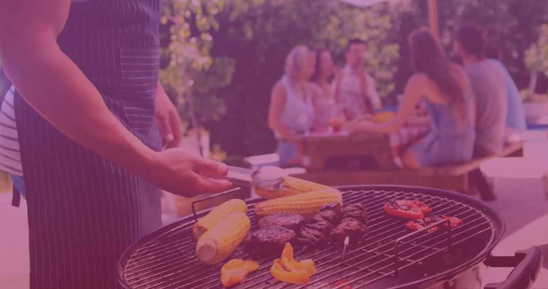 Friends Enjoying Outdoor BBQ Gathering in Summer Setting
