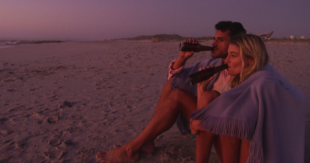 Couple Relaxing on Beach at Sunset with Beers - Free Images, Stock Photos and Pictures on Pikwizard.com