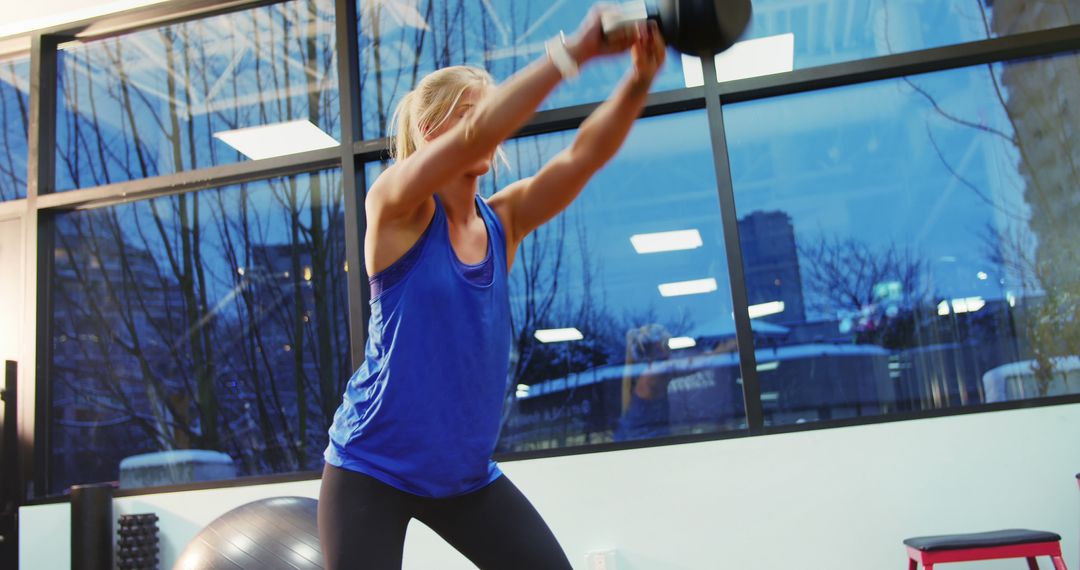 Woman Exercising with Kettlebell in a Modern Gym - Free Images, Stock Photos and Pictures on Pikwizard.com