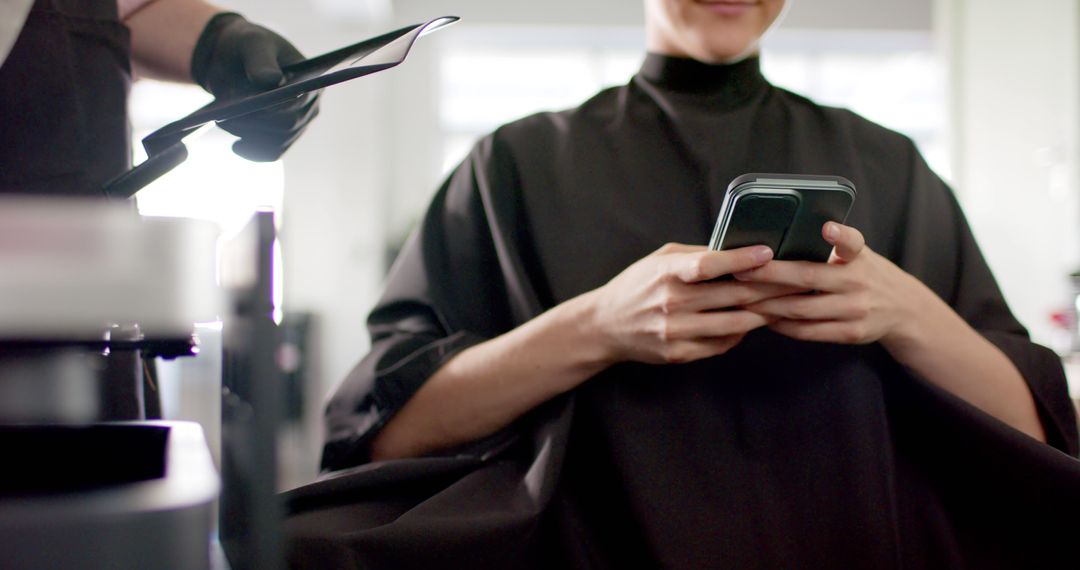 Woman Waiting for Haircut Texting on Phone in Salon - Free Images, Stock Photos and Pictures on Pikwizard.com