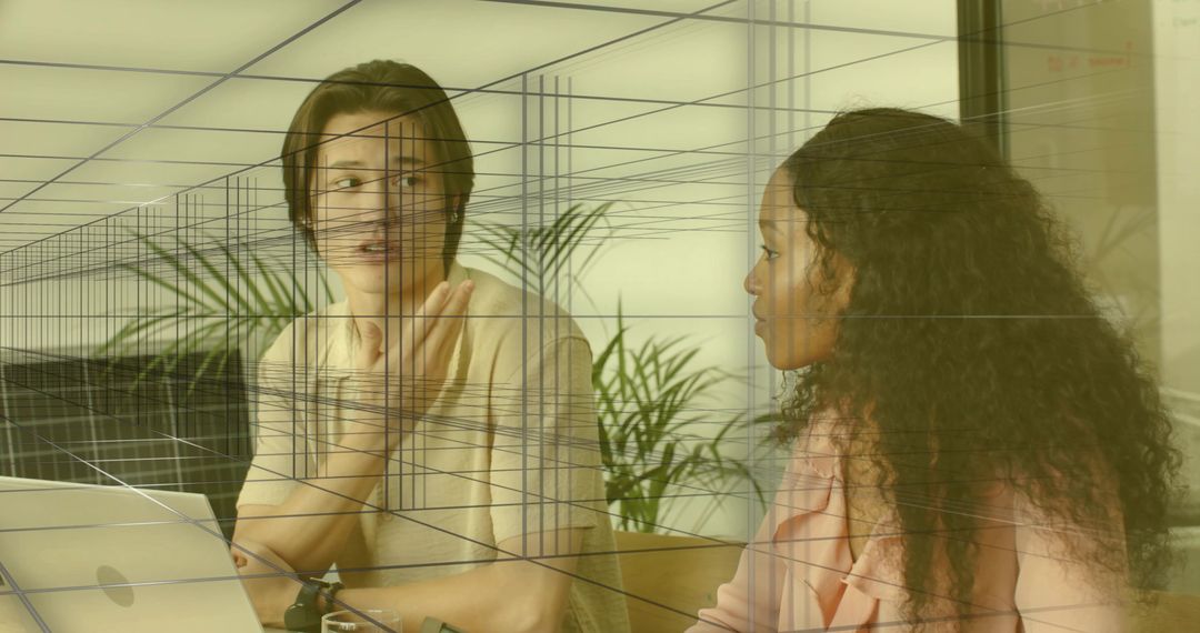 Office Coworkers Engaging in Creative Discussion with Laptop