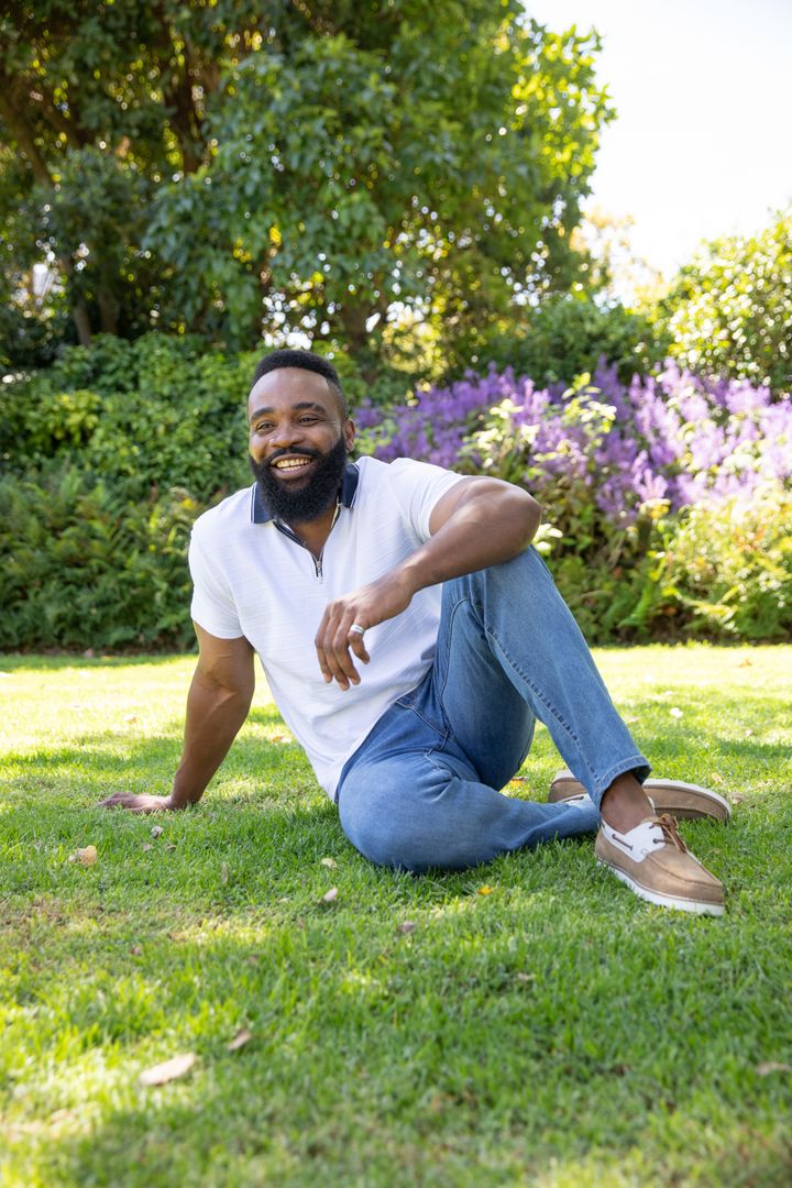 Relaxed Man Enjoying Sunny Day in Lush Park Setting