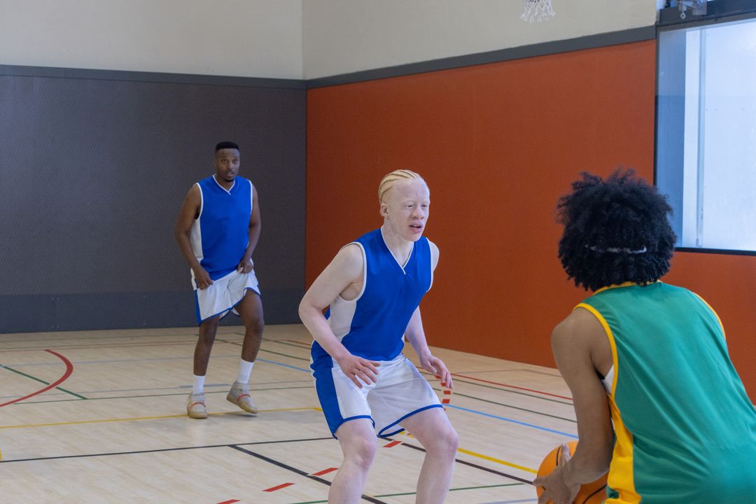 Diverse Athletes Engaging in Intense Basketball Game on Indoor Court