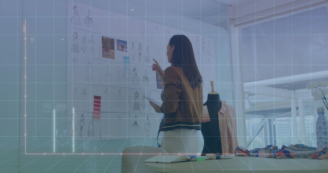 Fashion Designer Analyzing Dress Designs with Digital Interface