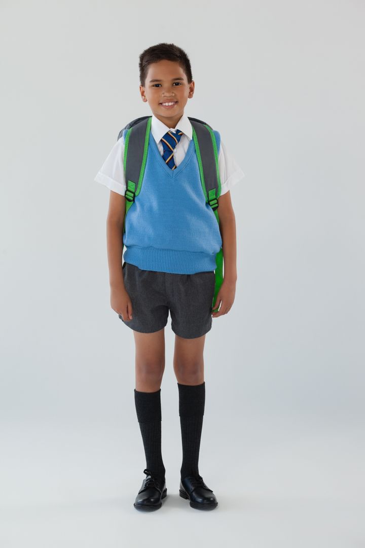 Schoolboy in school uniform with school bag on white background - Free Images, Stock Photos and Pictures on Pikwizard.com
