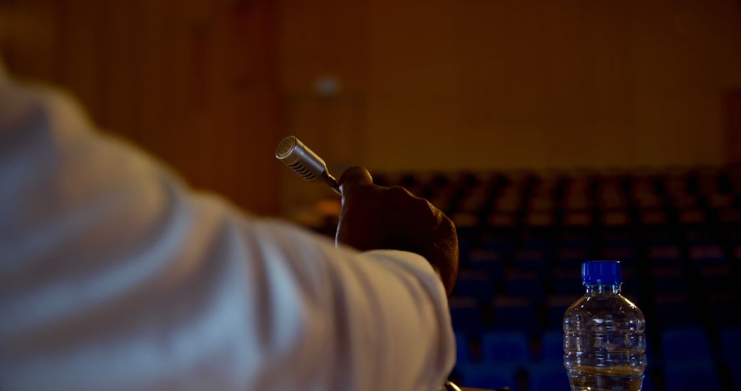 Businessman Preparing Speech on Stage with Microphone