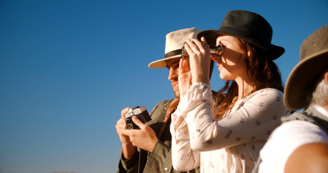 Explorers Observing Outdoors with Binoculars and Camera
