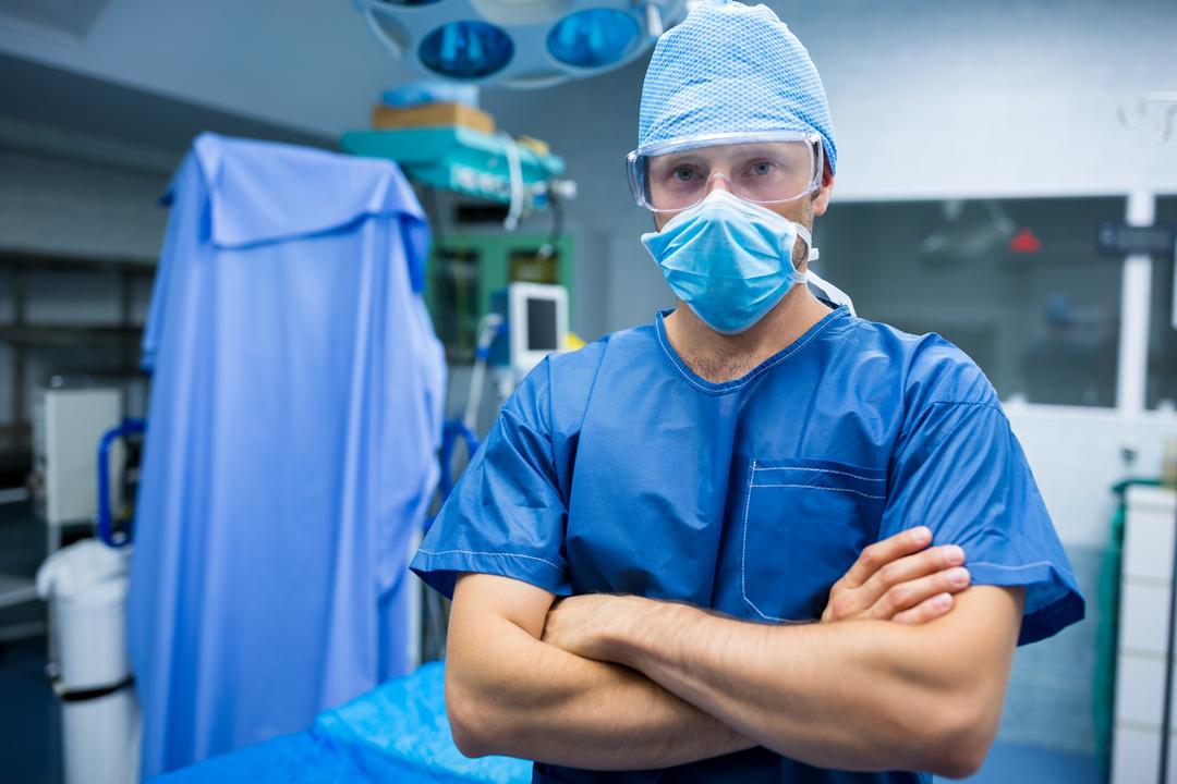 Confident Surgeon Standing with Arms Crossed in Operating Room - Free Images, Stock Photos and Pictures on Pikwizard.com