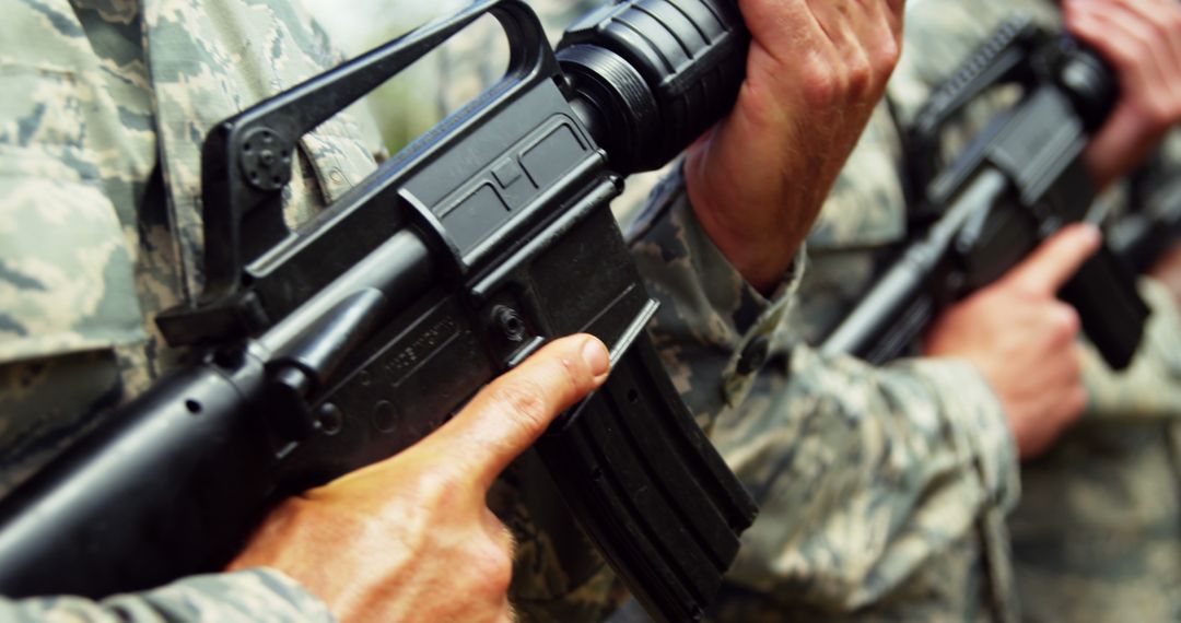 Soldiers Holding Rifles in Formation Close-up with Camouflage Uniforms - Free Images, Stock Photos and Pictures on Pikwizard.com