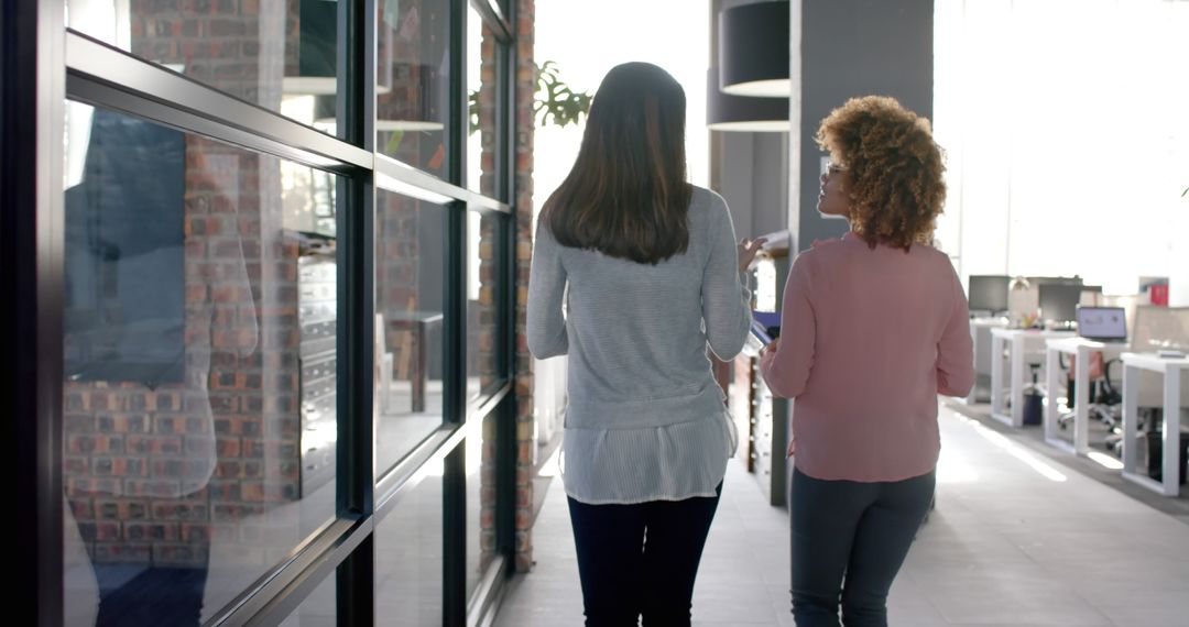 Two Businesswomen Talking in Modern Office Hallway - Free Images, Stock Photos and Pictures on Pikwizard.com